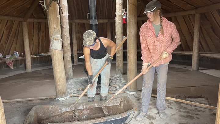 Pouring a terra tile floor in the earthlodge.