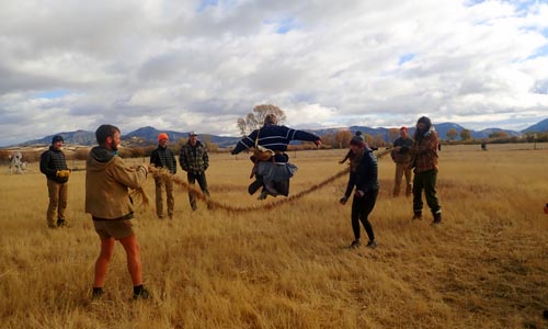 Playing jump rope with a grass rope.