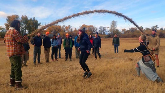 Playing jump rope with a grass rope.