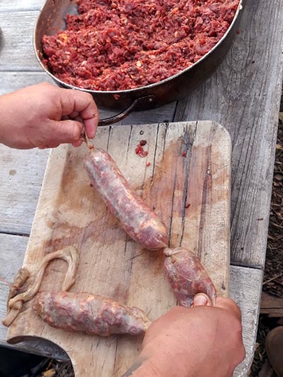Making sausage with natural gut.