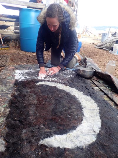 Wet-felting a moon design.