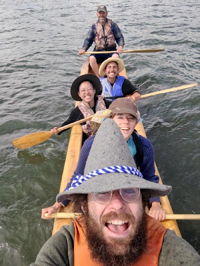 Group paddling a dugout canoe.