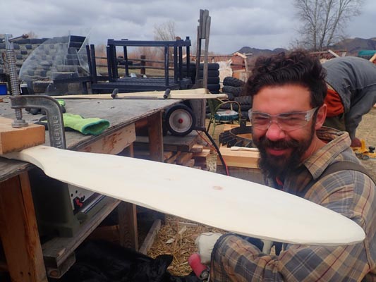 Student crafting a canoe paddle.