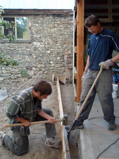 Installing form boards for a footing.