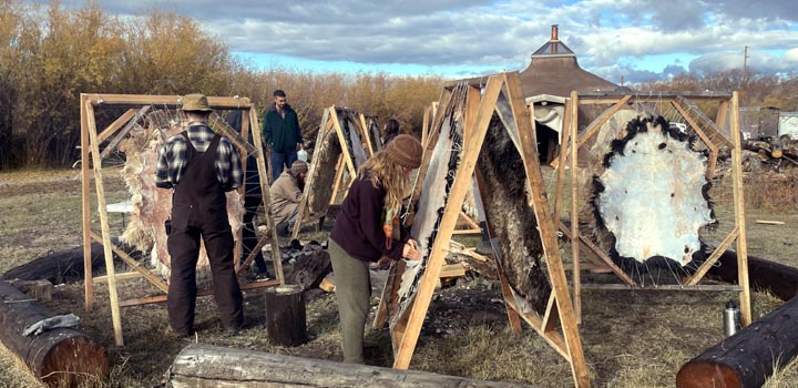 Students tan sheep hides at Green University LLC.
