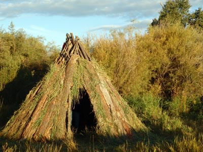 Slabwood wickiup, student housing at Green University.